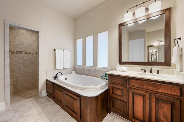 bathroom with a garden tub, tiled shower, and vanity