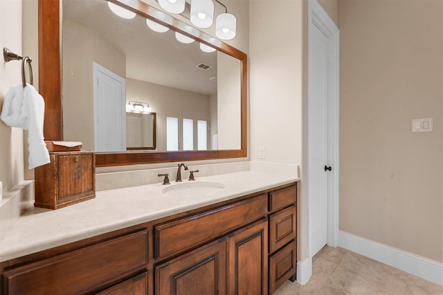 bathroom featuring visible vents, vanity, baseboards, and tile patterned floors