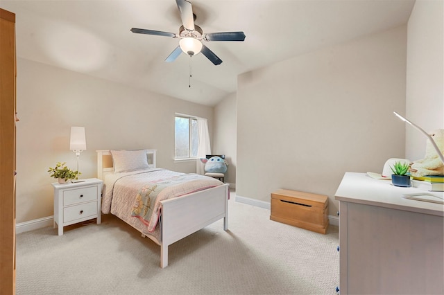 bedroom featuring light carpet, a ceiling fan, and baseboards