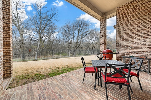 view of patio / terrace with outdoor dining space, a fenced backyard, and a grill