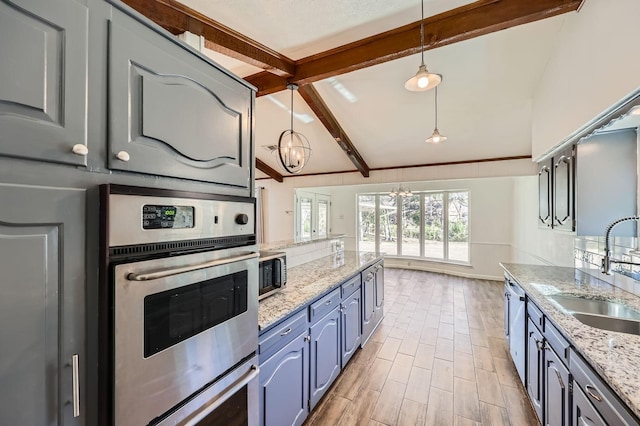 kitchen with vaulted ceiling with beams, stainless steel appliances, wood finish floors, a sink, and hanging light fixtures