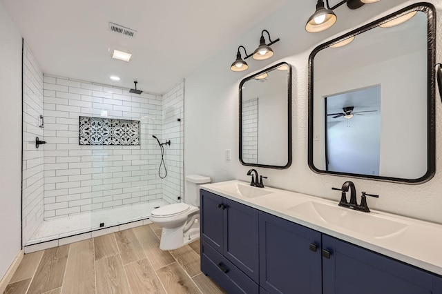 bathroom featuring wood finish floors, visible vents, a sink, and toilet