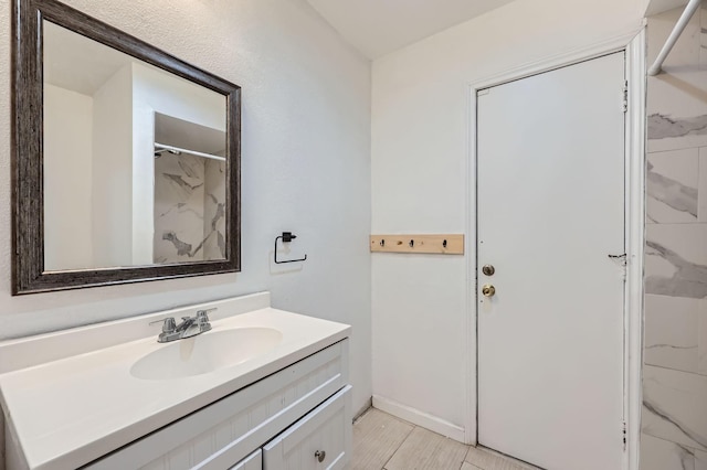 full bath with a shower and vanity