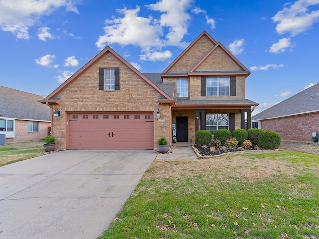 view of front of house with an attached garage, driveway, brick siding, and a front yard