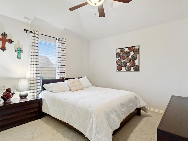 bedroom featuring ceiling fan, baseboards, vaulted ceiling, and carpet flooring