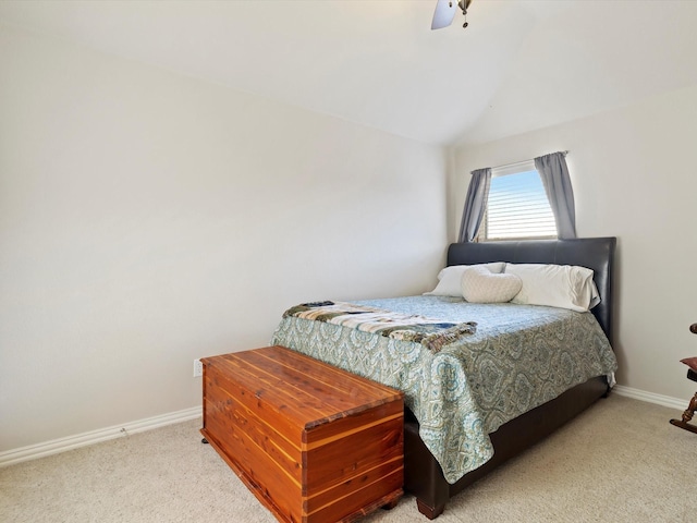 carpeted bedroom featuring lofted ceiling, ceiling fan, and baseboards