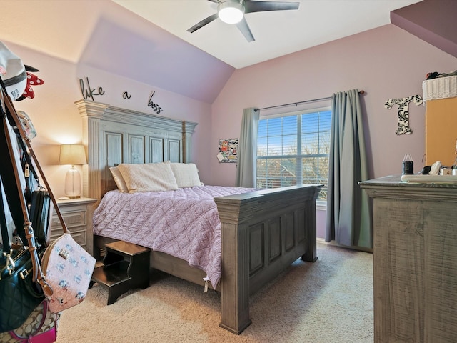 bedroom with a ceiling fan, lofted ceiling, and light colored carpet