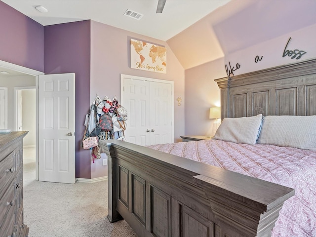 bedroom with a closet, visible vents, light carpet, vaulted ceiling, and baseboards