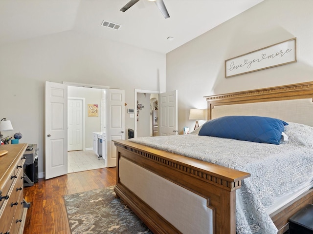 bedroom featuring lofted ceiling, ceiling fan, visible vents, and dark wood-style flooring