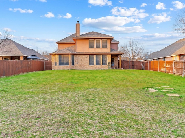 rear view of property featuring a fenced backyard, brick siding, a shingled roof, a yard, and a chimney