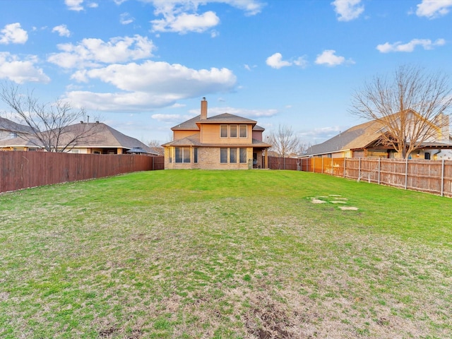 view of yard with a fenced backyard