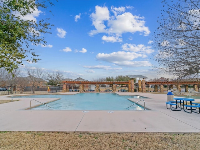 community pool featuring a patio and fence