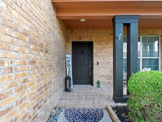 property entrance with brick siding