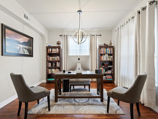 home office featuring a notable chandelier, baseboards, visible vents, and dark wood-style flooring