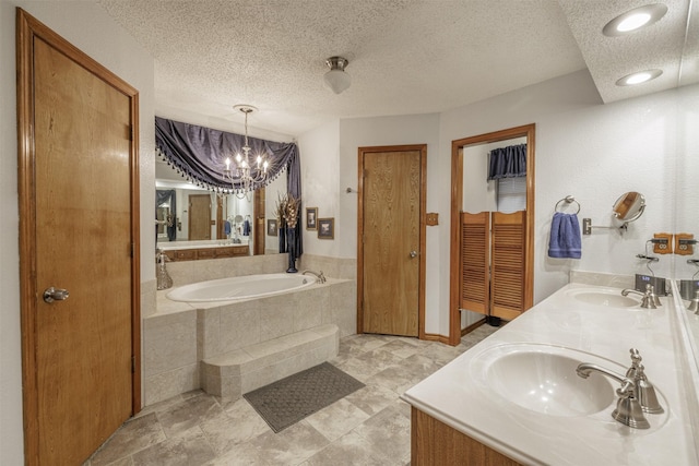 full bath with a textured ceiling, a sink, and a bath