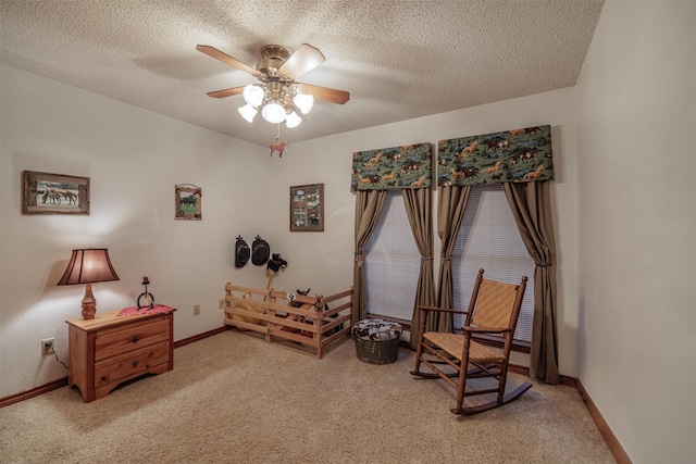 living area with light carpet, a textured ceiling, and baseboards