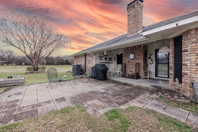 view of patio with central air condition unit, grilling area, and a ceiling fan