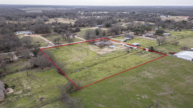 birds eye view of property with a rural view