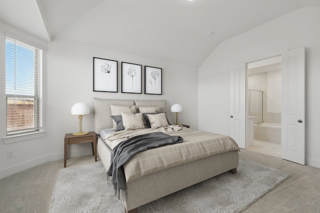 carpeted bedroom featuring baseboards, connected bathroom, and vaulted ceiling