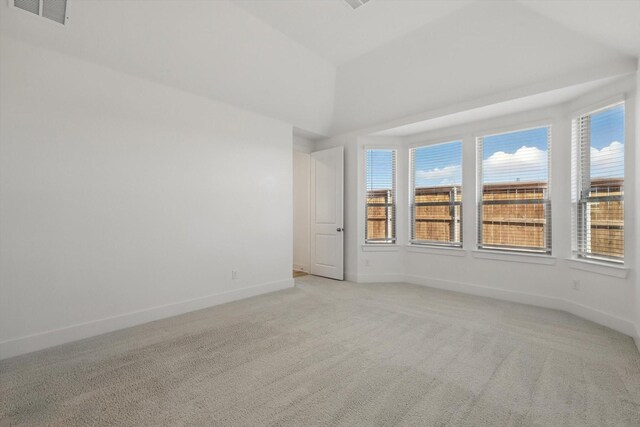 unfurnished room featuring baseboards, visible vents, and light colored carpet