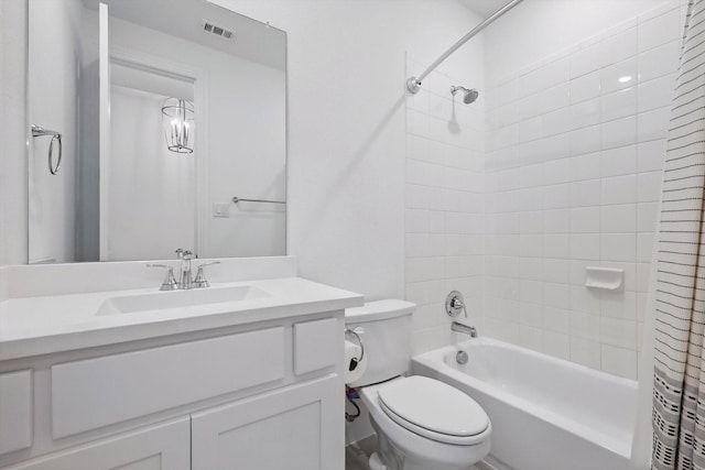 bathroom with toilet, vanity, shower / bath combo, and visible vents