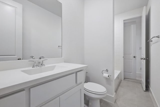 bathroom featuring baseboards, toilet, tile patterned flooring, and vanity
