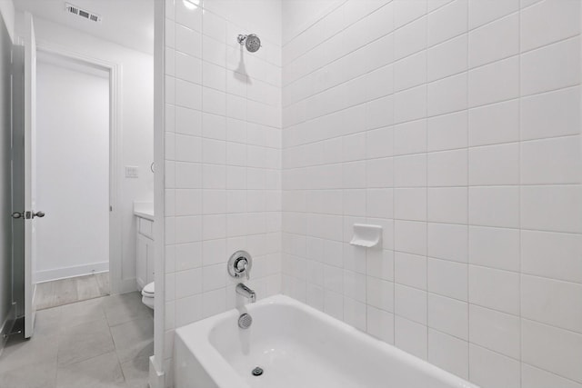 bathroom with toilet, bathing tub / shower combination, vanity, baseboards, and visible vents