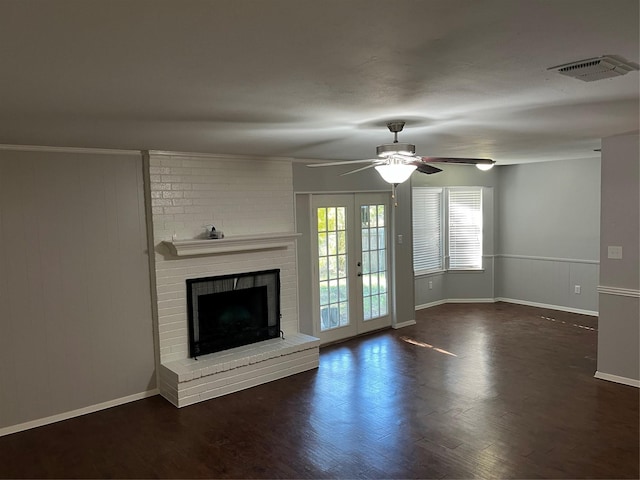 unfurnished living room with visible vents, a ceiling fan, wood finished floors, french doors, and a fireplace