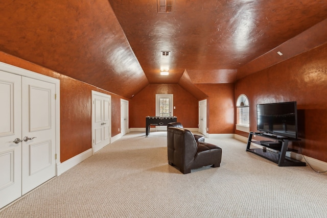 carpeted living room featuring lofted ceiling, baseboards, and visible vents