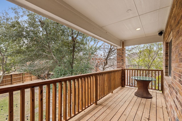 wooden terrace featuring fence