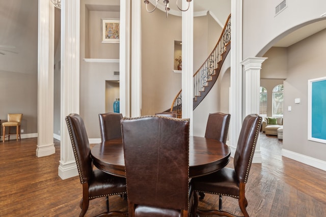 dining space featuring ornate columns, visible vents, arched walkways, and dark wood finished floors