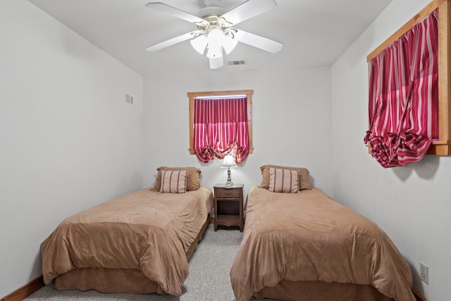 bedroom featuring a ceiling fan, carpet flooring, and visible vents