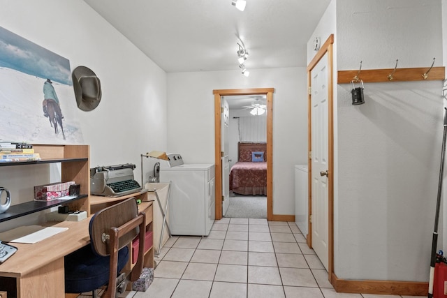 interior space with light tile patterned floors and washing machine and dryer