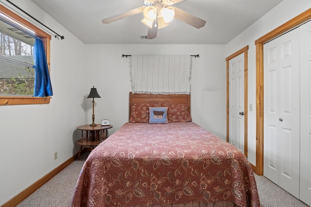 carpeted bedroom featuring ceiling fan, visible vents, and baseboards