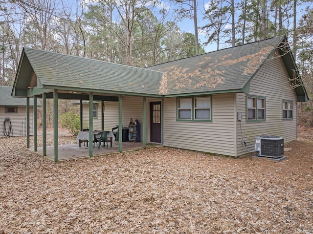 back of house with a shingled roof, central AC, and a patio