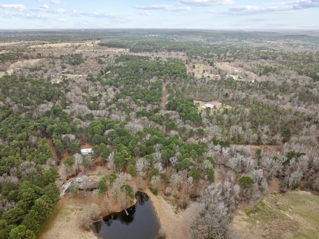 birds eye view of property featuring a forest view