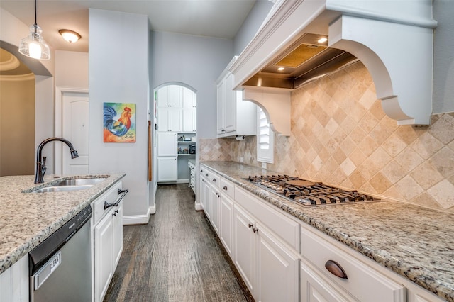 kitchen featuring dark wood-style floors, stainless steel appliances, white cabinetry, a sink, and premium range hood