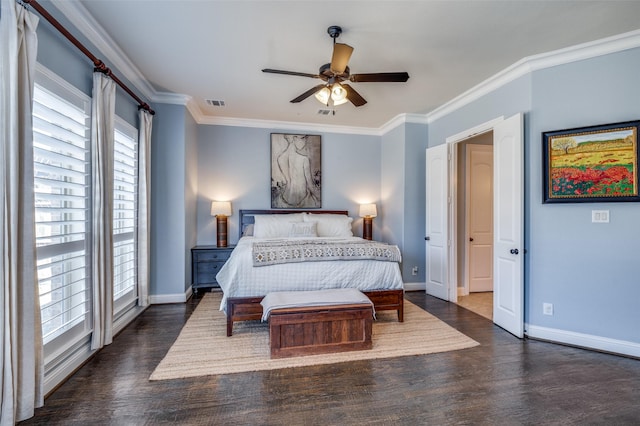 bedroom with dark wood-style floors, visible vents, and crown molding