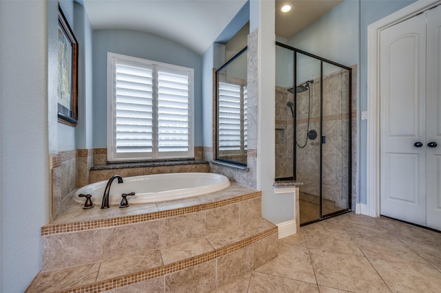 full bath featuring a stall shower, tile patterned flooring, and a garden tub