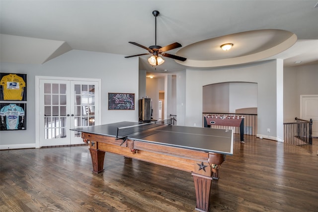 recreation room featuring a ceiling fan, baseboards, vaulted ceiling, french doors, and dark wood-style floors