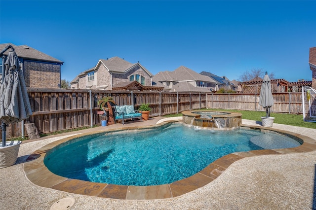 view of pool featuring a fenced backyard and a pool with connected hot tub