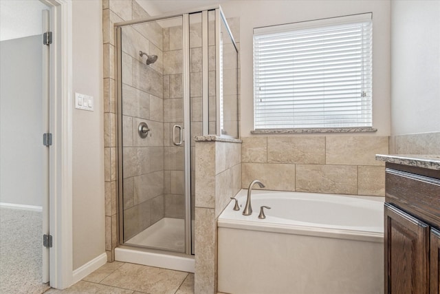 full bathroom with tile patterned floors, a shower stall, a bath, and vanity