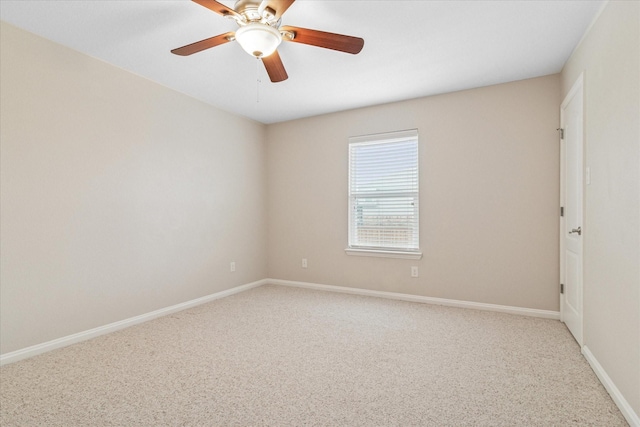 empty room featuring ceiling fan, carpet floors, and baseboards