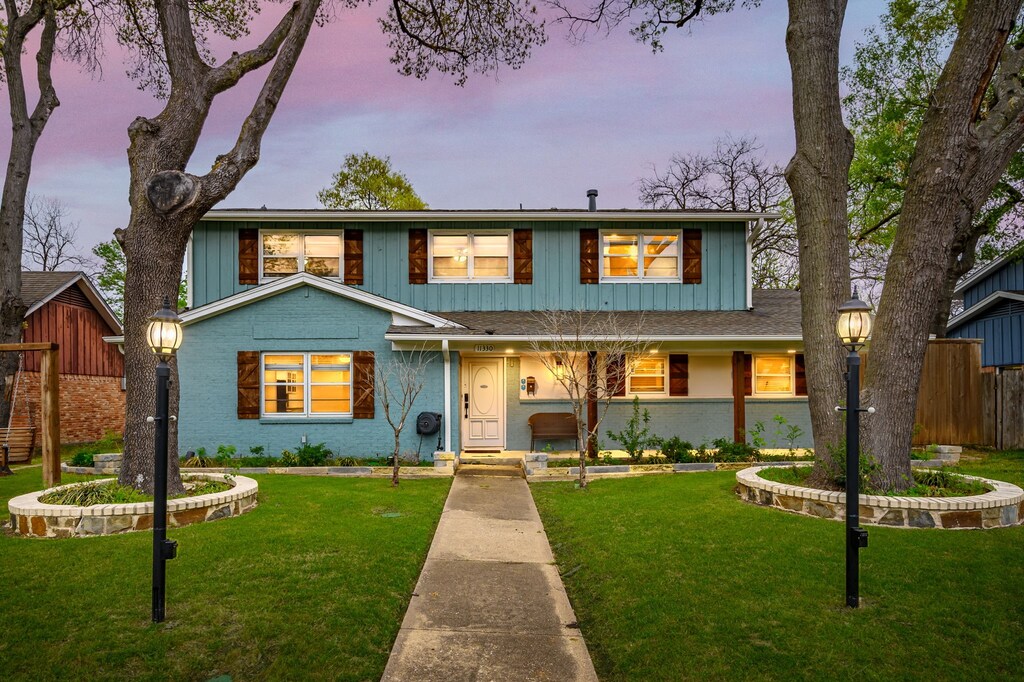 11330 Dumbarton Dr, Dallas, TX 75228 - traditional-style home with a lawn, fence, and board and batten siding