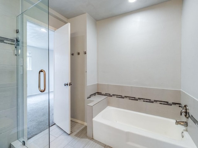 full bathroom with a stall shower and a bath