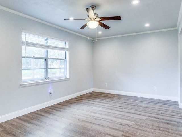 unfurnished room featuring ornamental molding, baseboards, and wood finished floors