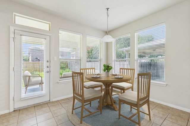 dining area with light tile patterned flooring and baseboards