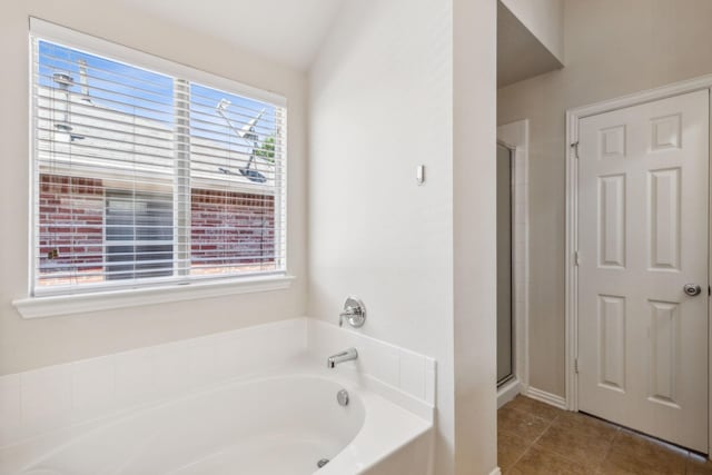 full bath featuring a garden tub, tile patterned flooring, and a shower stall