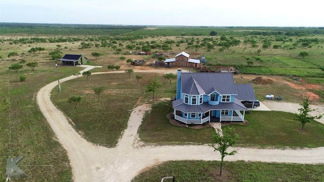 birds eye view of property with a rural view