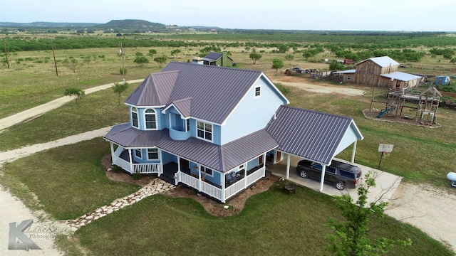 birds eye view of property featuring a rural view